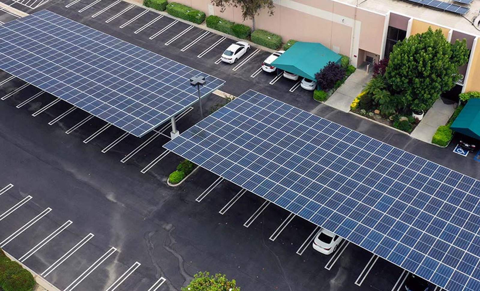 Two solar carport canopies over the parking lot of a commercial building in Chatsworth, built by Current Energy