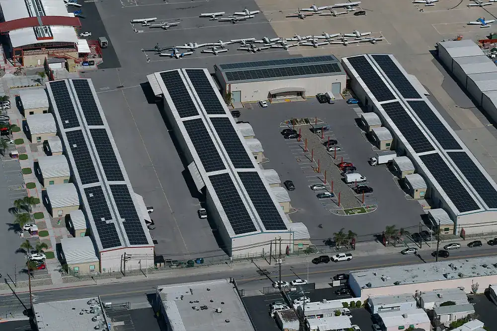 Aerial view of solar panels on multiple hangar roofs at Van Nuys Airport