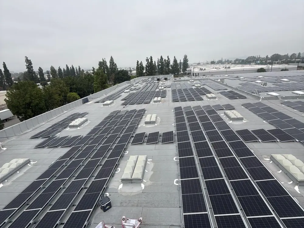 Solar panel rows across a large warehouse roof in Southern California, installed by Current Energy