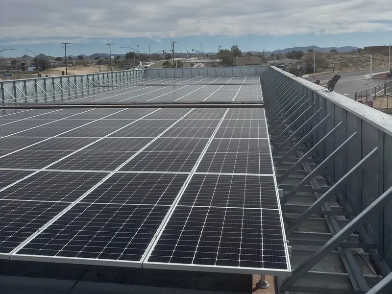 Solar canopy array over a retail parking structure built by Current Energy