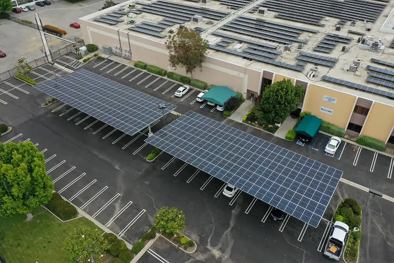 Aerial view of two solar carport canopies over a commercial parking lot