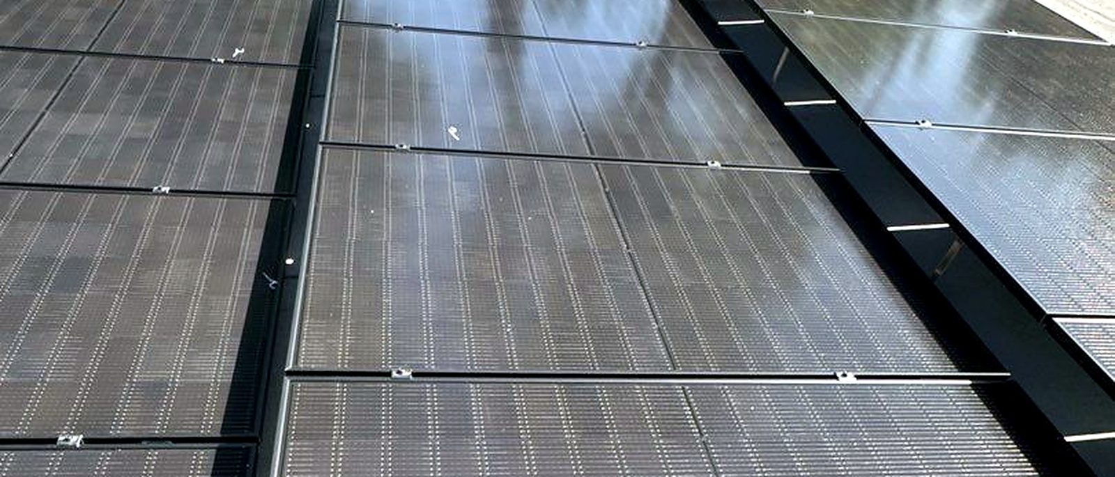 Tilt-mounted solar array on a flat roof, installed by Current Energy