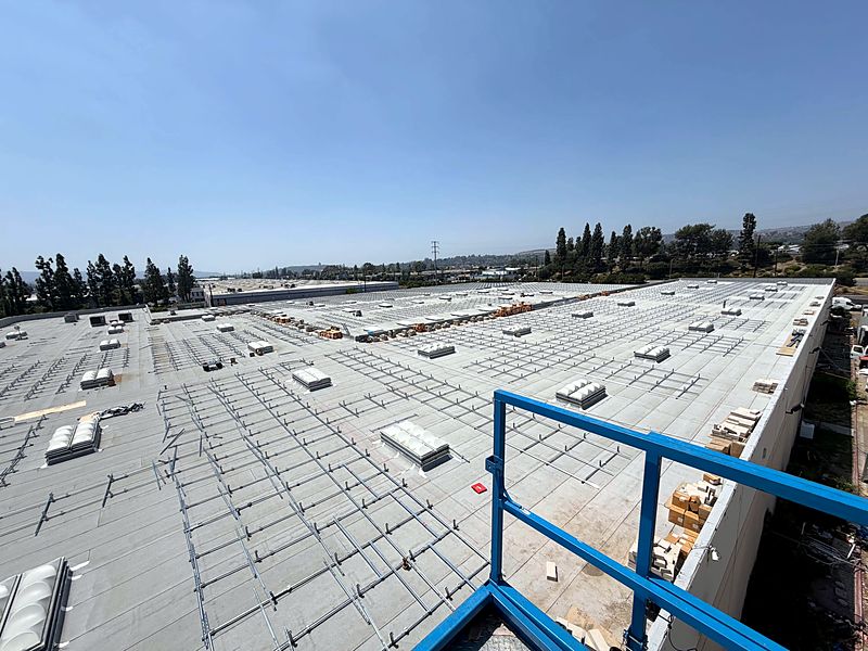 Commercial roof with solar racking laid out before the modules
