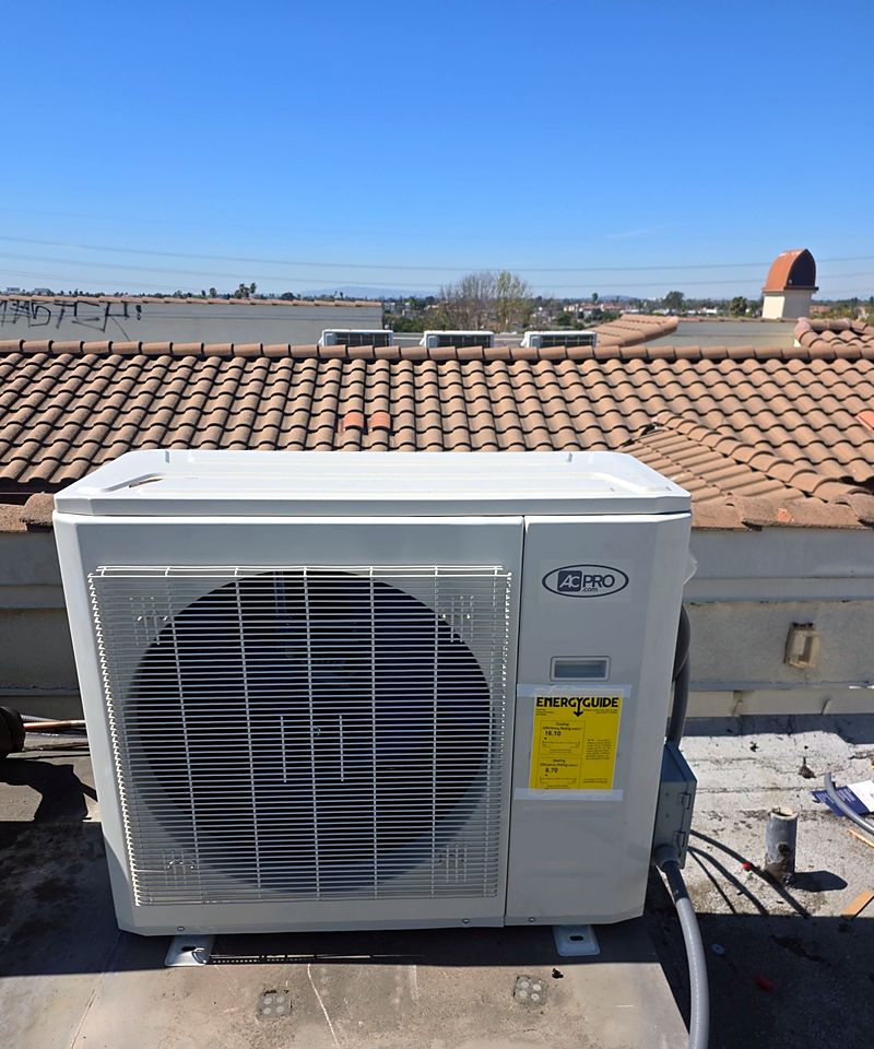 Heat-pump condenser installed at a tile-roof building