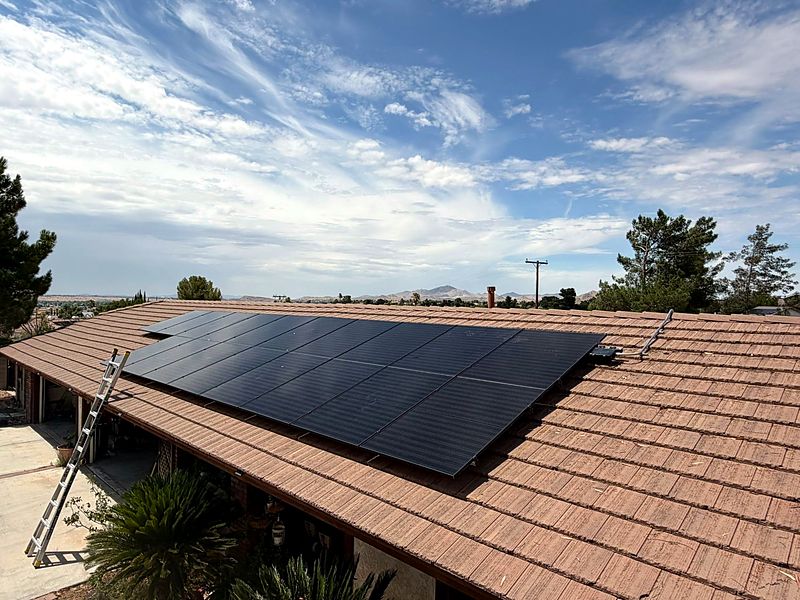 Solar array on a tile roof with foothills behind
