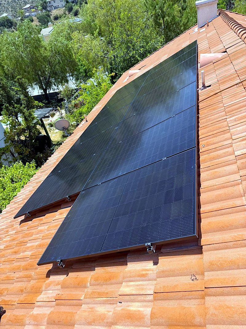 Residential solar array on a red tile roof