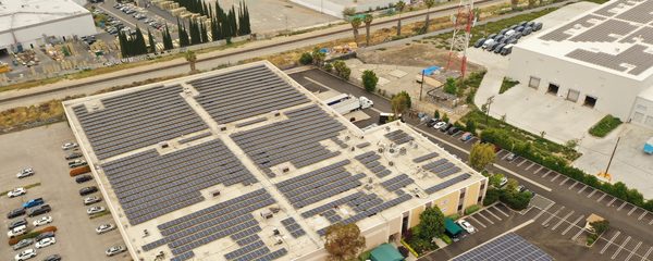 Aerial view of the Chatsworth commercial building with a rooftop solar array and two solar carports
