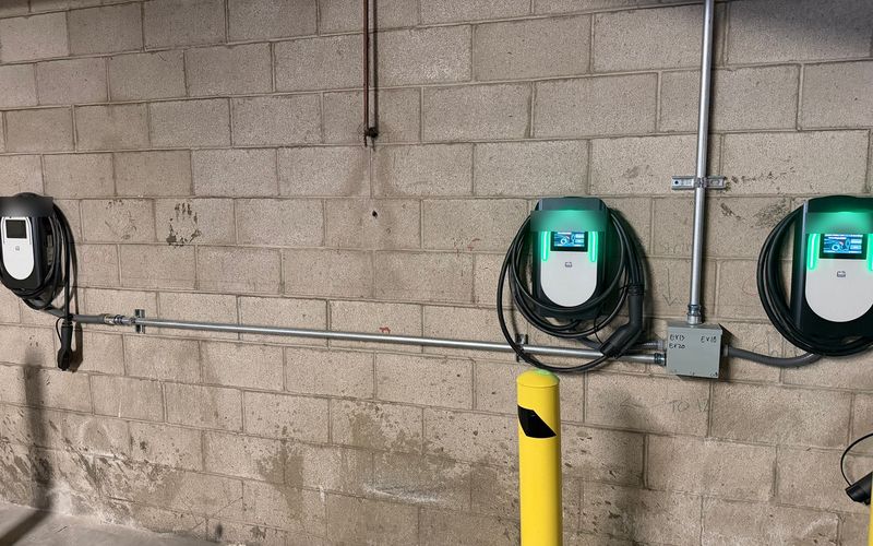 Wall-mounted EV chargers in a multifamily parking garage