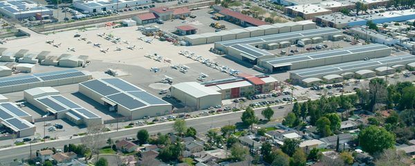 Wide aerial view of Van Nuys Airport hangars with rooftop solar