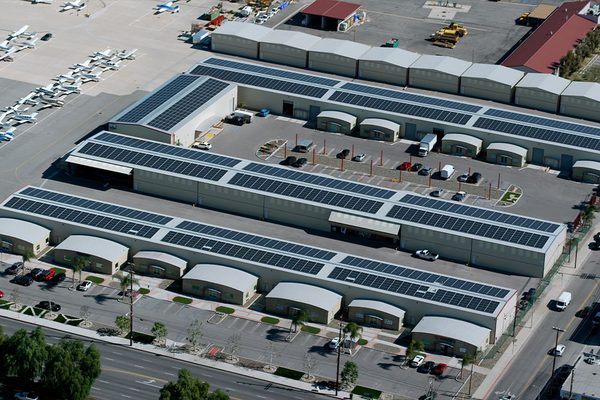 Close aerial view of solar panels across several hangar roofs at Van Nuys Airport