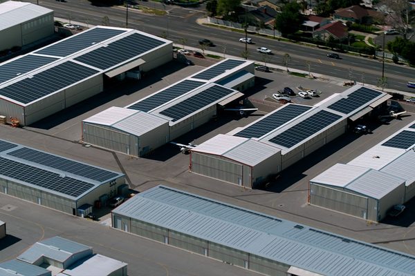 Solar arrays on hangar roofs beside an aircraft parking area at Van Nuys Airport