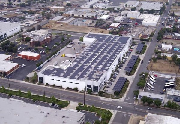 Aerial view of the Vitco Foods building with solar on the roof and over parking