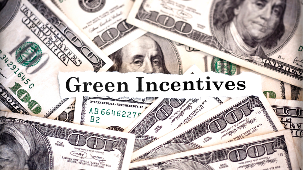 Green Incentives text on top of scattered one-hundred dollar bills